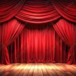 Vintage theater stage with red curtains, wooden floors, and dramatic spotlight lighting.